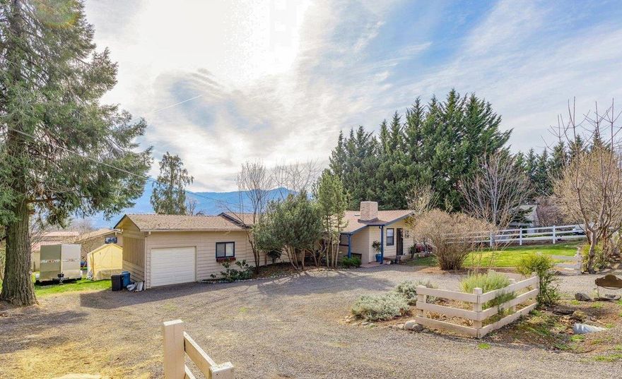 Million dollar views in Ashland! This beautiful home sits on half an acre in Ashland on Wilson Road off of N. Valley View Road. There are three bedrooms, two full baths and a separate study/office off of the garage. New hardwood floors and carpets throughout the house were installed in 2018. New granite counters in the kitchen. There is a charming open beamed ceiling in the living room. The family room has vaulted 12 ft. ceilings with large windows, inviting the light in. There are two decks, one off the master bedroom and a much larger one off the family room that is perfect for entertaining. There is a large detached 500 sq.ft. artist studio with vaulted ceilings, plus a 240 sq.ft. storage shed. There is TID irrigation for the half acre plus abundant fruit and nut trees. Located on the sunny side of Ashland, it is a true Southern Oregon Retreat!