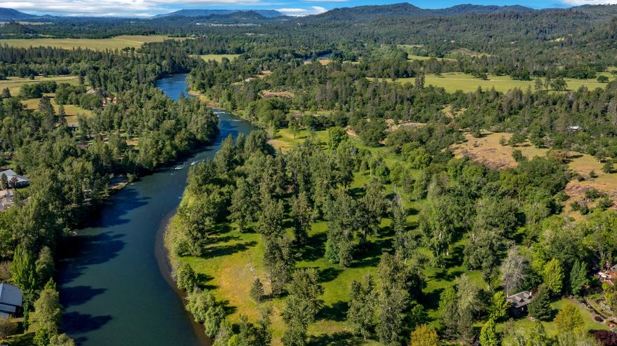 Rare offering of a legacy ranch encompassing over 144 acres just outside Shady Cove, Oregon. This exceptional property combines development-ready land with prime irrigated farmland and Rogue River frontage—a one-of-a-kind blend of opportunity, beauty, and location. Located within the UGB, the 55+ acres zoned RR5 allow for 5-acre lot development. Sewer hookups are in place, significantly streamlining the path to subdivision. All lots would feature Rogue River access and views, making this an ideal canvas for a luxury riverfront community. The remaining 88+ acres offer flat, fertile farm ground, fully irrigated and ready for vineyard, equestrian, or livestock ventures. The property's proximity to the Medford Intl Airport and all So. Oregon amenities adds further value. Whether your vision includes a high-end rural subdivision, a working farm, or a trophy legacy estate, this property delivers on every front. A truly rare chance to own premier land with water, zoning, access, and scale.