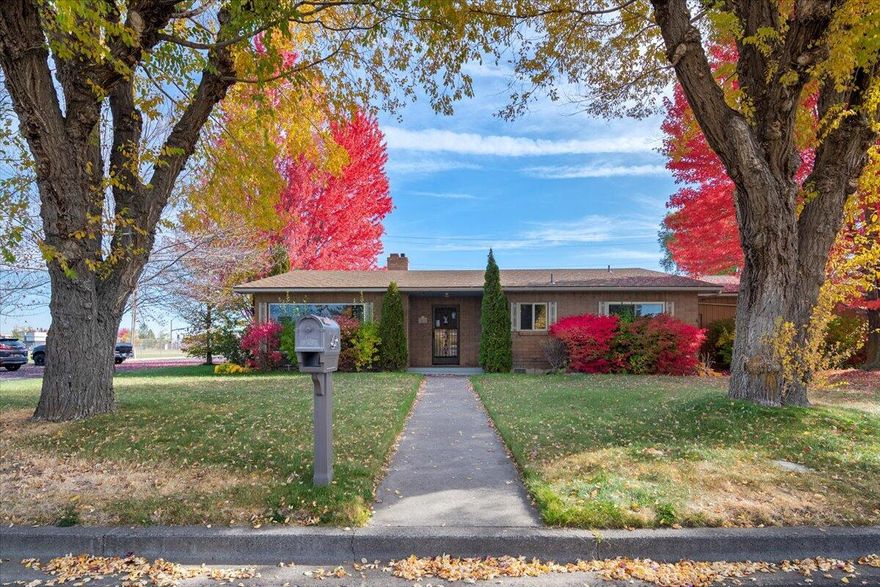 Set on a beautiful corner lot across from the school, this single-level home is tucked into a surprisingly quiet neighborhood surrounded by mature trees that come alive with color in the fall. Inside, the ranch-style layout offers a spacious and thoughtful flow, including a generous primary suite and multiple living areas that showcase the solid craftsmanship of its era. With alley access to the garage and carport, plus a small enclosed area perfect for RV, boat, or trailer storage, this home is as functional as it is full of potential. A perfect opportunity for someone ready to bring fresh style and modern updates to a home with great bones and timeless structure.