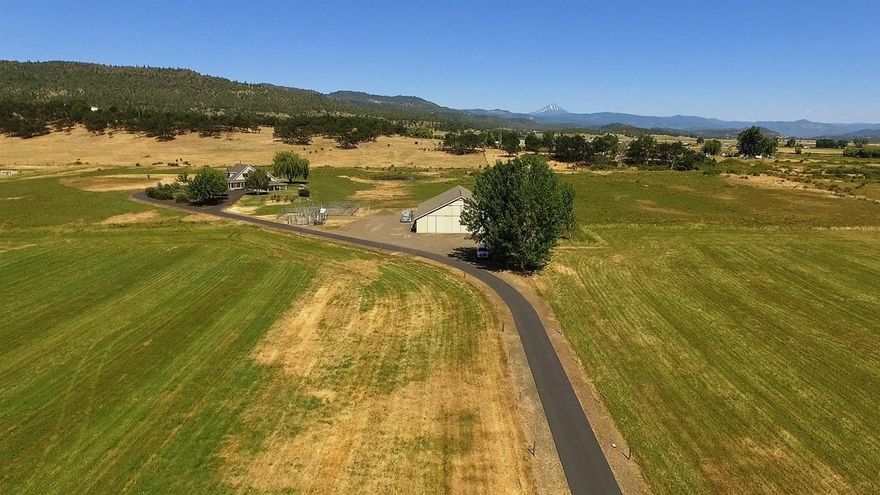 Highly desirable 58 ac EFU zoned farm with 58 ac of irrigation water rights in Eagle Point, OR. The property is currently set up for hay & cattle, fully fenced & cross fenced with 2 large old spring fed ponds. The gated paved driveway leads you to an impeccably maintained custom build 3200 sq ft 5 bdrm 4 bthrm home with office bonus room & beautiful spacious updated kitchen with granite counters & all stainless appliances & ample storage. Large master suite is on the main level & boasts a huge walk-in closet with built-in custom storage unit. The upstairs has 4 bedrooms and is perfect for a big or growing family. The landscape is auto sprinkled with lovely water feature & stunning views of the Rogue Valley & Mount McLaughlin. There is a massive barn 64'x84'with heated shop with compressor & hoist for equipment maintenance & 200 amp service. The barn also has full bath, washer/dryer & several massive bays with feeder stalls for cattle or easily converted to horse stall. The farm histo