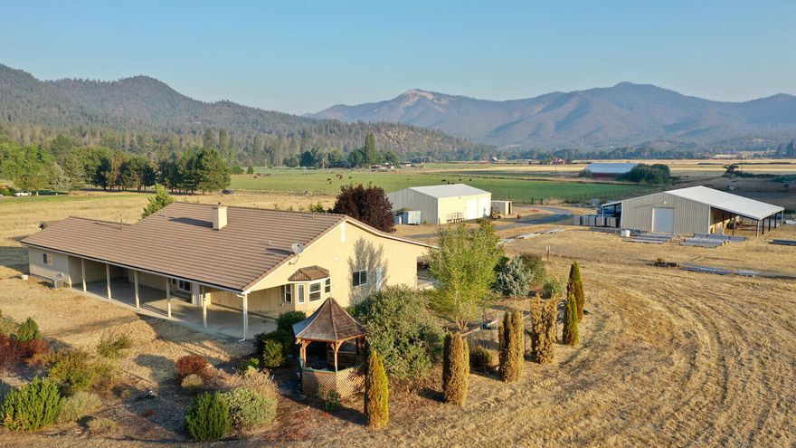 Beautiful Applegate Valley holding with just over 11 fully irrigated acres with senior water rights dating back to 1857. This private, gated property holds a custom single-level stucco 3BD/3BA home in which you will find an open floor plan with natural lighting, tall ceilings & custom details. The kitchen has plenty of custom cabinet space & offers granite counters, a large island & bar seating. The spacious master holds room for you to unwind & offers an extra nook perfect for today's coveted home office. Outside is where the property really shines with an oversized detached 2-car garage, a large barn with 4 stalls for the equestrian enthusiast, and a large insulated shop with roll-up doors that is big enough for all the projects that you can imagine. A new 80,000sft pad is ready for a riding arena, additional buildings, or? This is the ultimate hobby farm, equestrian getaway, or simply a quiet retreat in the heart of Southern Oregon Wine Country.