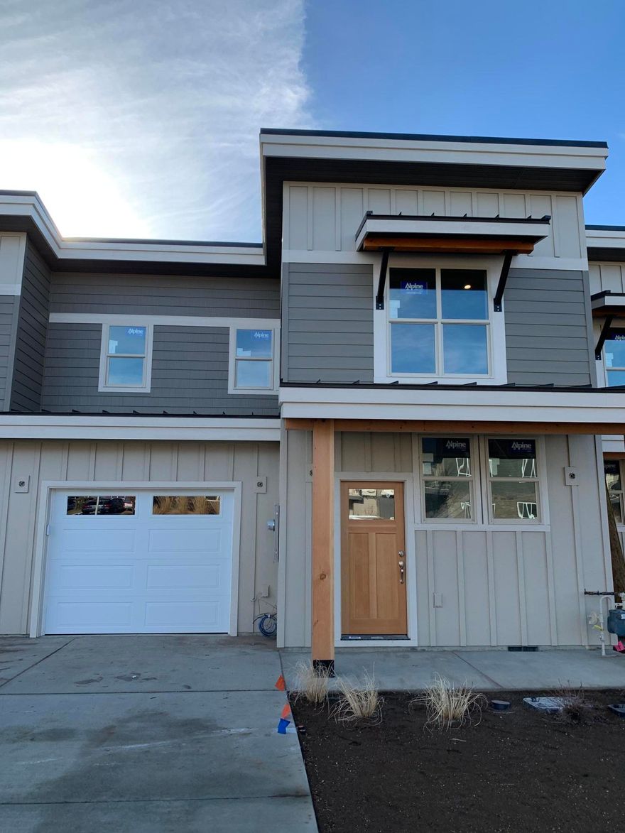 Welcome to the first 6 townhomes at the Village at Ridgeview!  Upscale interior finishes include stainless steel appliances, iced white quartz countertops, ivory Paradigm Performer vinyl plank floors, nickel finishes, and a gas fireplace.  The heart of the home kitchen features white mantra cupboards, a downdraft range, dishwasher and microwave.   Plenty of space for all your hobbies in this 3 bed/2.5 bath home and the vaulted ceilings on both floors make it feel even roomier.  The laundry is conveniently located; check out the floor plan! A/C.  The extra long garage has a steel door with glass and room for storage or a workbench.  The fenced yard and south facing back patio are perfect for pets and  BBQs with your friends and family.  Conveniently located in a beautiful new neighborhood near Ridgeview HS, this is the 3rd townhome in from the west. Open Houses often or call for an appointment,under construction.  Price drop due to floor plan change. Visit soon!