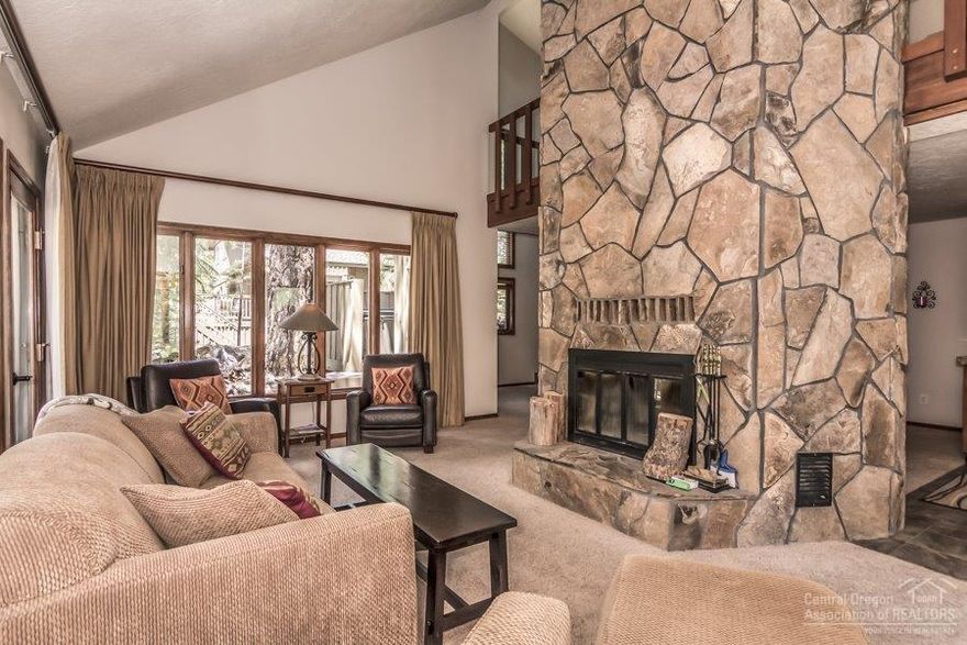 High mountain cool with a dash of modern. 1 Pine Ridge Lane has a unique, open two-story design with a massive stone fireplace as its centerpiece. The large loft serves as a comfortable gathering area or a space for overflow guests. An updated kitchen and master bath add an upscale touch. The terraced deck has a hot tub and room for BBQs. Centrally-located close to Ft. Rock Park with easy access to more than 33 miles of paved walking/biking paths, two championship golf courses, horseback riding, river rafting, and world class winter activities. Sunriver is where memories are made, start make yours today.
