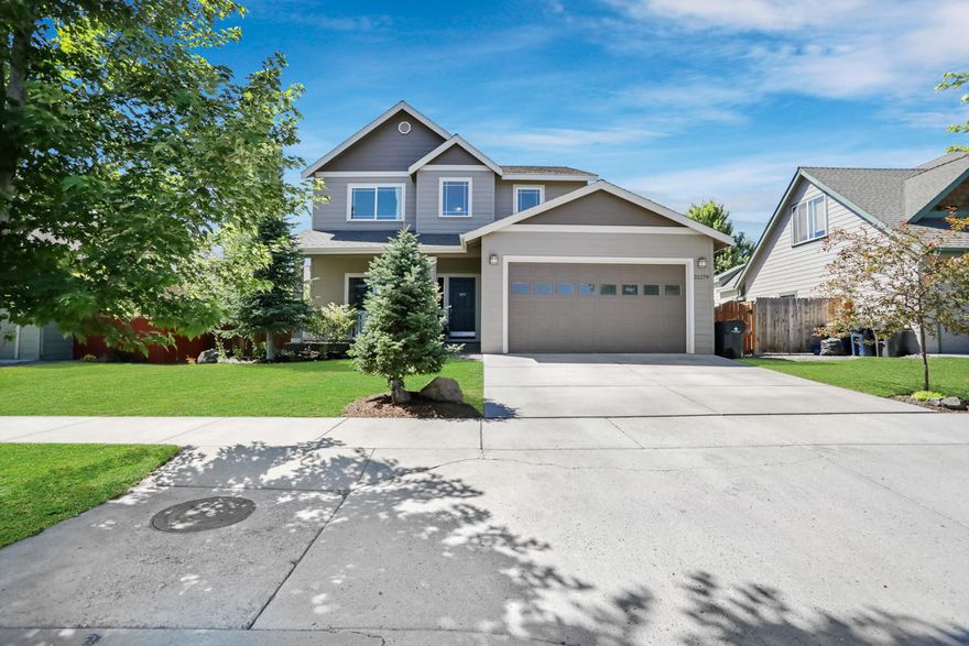 This charming SE Bend home has 2000+sq feet of open living space. Upon entering this light and bright home, you will find an updated office space with french doors and a barn door that leads to the butlers pantry and open kitchen with gas cooktop and kitchen island.  Hardwood floors throughout!  The open living area welcomes you with a gas fireplace and doors going out to the large fenced back yard with a paver patio, mature trees, perfect for entertaining!  Upstairs you will find a bonus area, two bedrooms and the master bedroom which has a soaking tub for cold winter nights and a walkin closet. Great neighborhood, very close to the canal and trails. Double car garage, welcoming front porch, as well as new heat pump installed in 2016 as well as new exterior paint in April 2020.