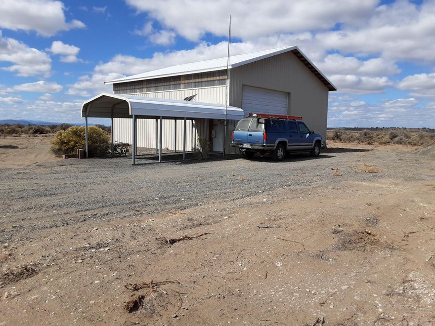 36 x 36 Pole Barn with Concrete Floor on large 40 acre level parcel. Solar heater in pole barn.  370 Ft Well, with 500 gal storage container plus 2 carports. Electric is approximately 3/4 mile from property.   Gorgeous view of the hills and desert, located not far from the town of Christmas Valley.  Farm Tractor and Implements include in the sale