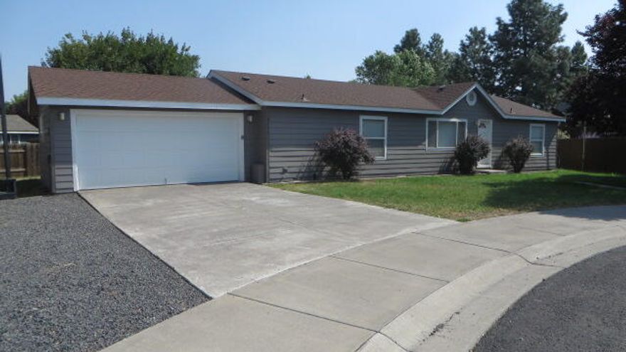 This home is situated on a quiet cul-de-sac in the suburbs and surrounded by newer homes.  It was manufactured in 2000 and has been nicely maintained.  The home features a split-bedroom floor plan with 4 bedrooms, 2 baths and even a bonus room just off the attached double car garage.  The kitchen has a pantry closet, and all the appliances are included.  It has an open living room and dining area with sliders leading out to a deck in the fenced back yard. The cul-de-sac lot has a large side yard next to the garage so there's plenty of extra parking for you travel trailer or RV.