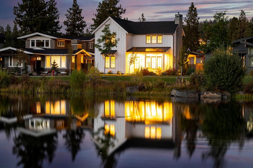 Dreamy modern farmhouse tucked along one of the most coveted streetscapes in all of Central Oregon, where runners and walkers enjoy a quiet loop around the serene lake and acres of grass in Northwest Crossing's Discovery Park. Here, detailed craftsmanship by Structure Development seamlessly melds authentic, well-planned design with warm farmhouse touches, including wooden beams, oil finished plank floors, farmhouse sink, and clean modern subway tile. At the heart of the home lies the great room and kitchen, as well as access to the patio for cooking, dining, and entertaining in all seasons. The main level accommodates a sweeping master suite with walk-in shower and closet, radiant heat flooring & soaking tub, with additional main level guest suite. Two bedrooms and a bonus room on the second floor provide great views of the park and the lake. Just blocks away from NW Crossing Community, including trails, restaurants, schools, and more!