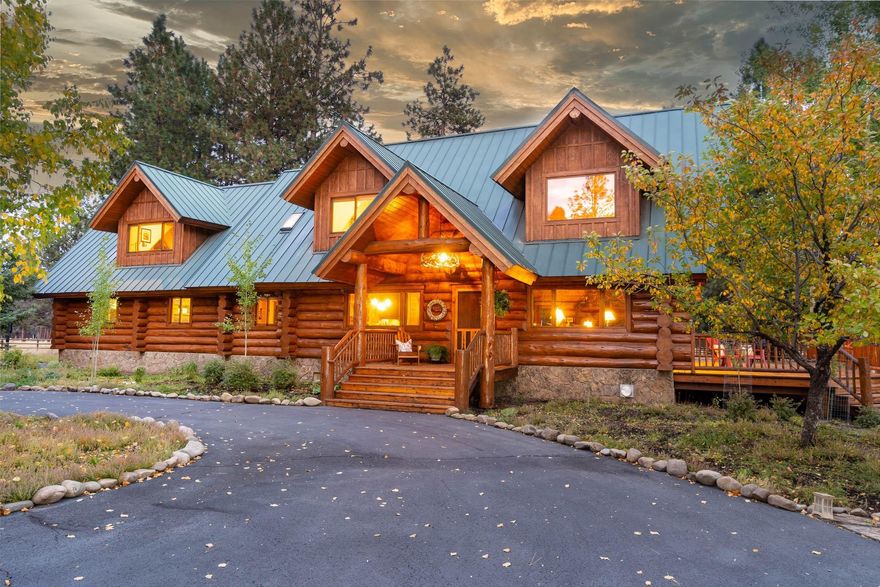Live your dream! Newly remodeled inside & outside, beautiful hand-made log home includes 5.62 private ac. Just minutes to town and public lands. As you enter the property and meander down the long circular drive, you'll be surrounded by manicured landscape, ponderosas, and aspens. A covered porch welcomes you to a 4 bedroom home where an open floor plan boasts a 30' vaulted great room of soaring glass and a floor-to-ceiling stone fireplace exuding warmth, character, and old world craftsmanship. Updated entertainer's kitchen opens to a wrap-around cedar deck and private sitting areas. Upstairs greets you with open sitting area/loft, large master suite and two additional bedrooms w/ full bath. Downstairs is a newly finished 1,152sf basement theater/bonus room. Two large garages, new professional caliber woodworking shop, heated tack room & loafing sheds for the horse enthusiast add to the desirable features of this unique estate. STATIONARY TOOLS AND MOST FURNITURE INCLUDED!