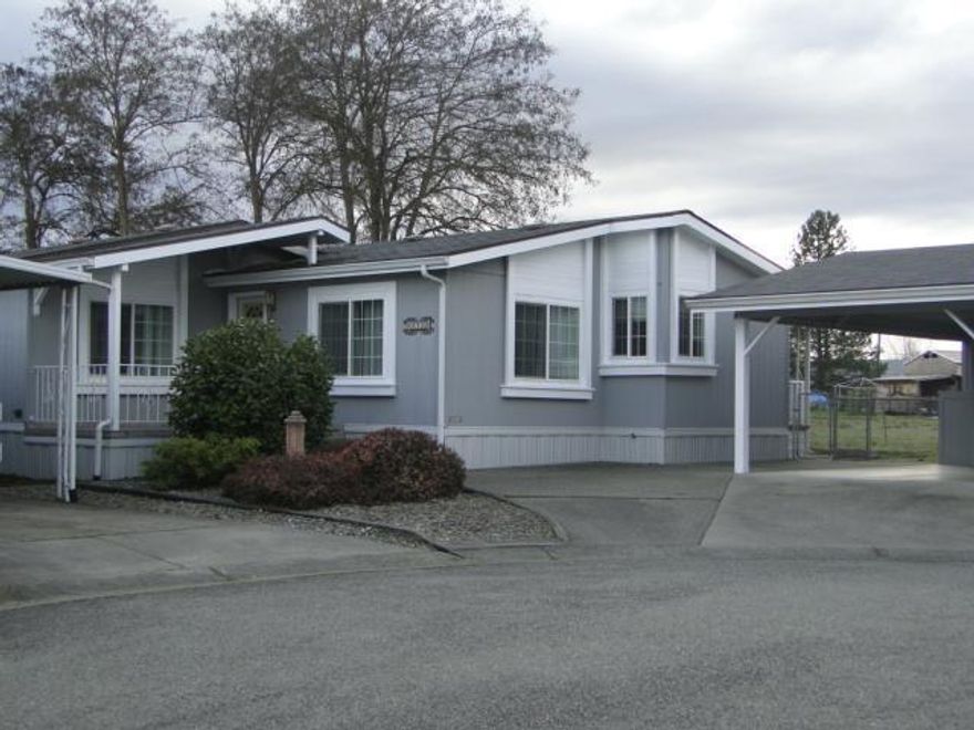 Very nice, bright home ready for move-in. Assessor's records show it as doublewide, but it seems much bigger, almost a triple wide. Lots of cabinet space in spacious kitchen and bathrooms. Back deck overlooks field giving you a sense of privacy. Carport holds 2 cars.