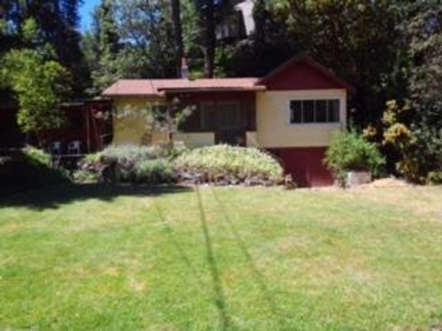 Vintage home tucked away in The Cove located in Shady Cove Oregon. This cutie is in need of some repair. The Cove is a small development of homes that share access to 1000 feet of river frontage. This common area provides the home owners with river access, fishing, swimming, and picnicking. This property is in a great location in the Cove with nice views and is located in close proximity to the river access area. Original hardwood flooring, eat in kitchen and separate dining area, spacious living room with nice views. Buyer to do own due diligence regarding property. Cash only. Property is sold as-is. Sellers are motivated. Bring your offer for consideration.