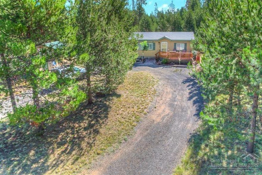 What a gorgeous home! This house is beautifully updated and remodeled, is turn key ready and close to the Deschutes River. It offers a nice open great room design, separation of bedrooms, large decks, fencing and covered parking. The heat pump is new, the privacy is superior, there is a nice storage shop, circular drive, and so close to the boat ramp too!