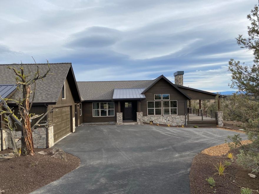 One-level new construction home with  Cascade Mountain views and an ideal location on a quiet street yet close to amenities. The exterior features stained wood siding and extensive stone accents. This home has a commanding sense of arrival as you enter the foyer. It is ideal for the entertainer with a large great room, dining room and beautiful kitchen. The kitchen features stainless steel appliances and a walk-in pantry. Slab countertops and island are perfect for the home chef. Beautiful hardwood flooring throughout the majority of the main level, a stone double sided fireplace in the great room that keeps you warm inside and outside on the large deck where you can catch the sunsets while entertaining guests or relaxing with a book. The master suite is an oasis with a walk-in closet, soaking tub and patio access through a vestibule. There is also a den ideal for an office, two additional bedrooms, full sized bathroom and a utility room. An oversized three bay garage finishes the home