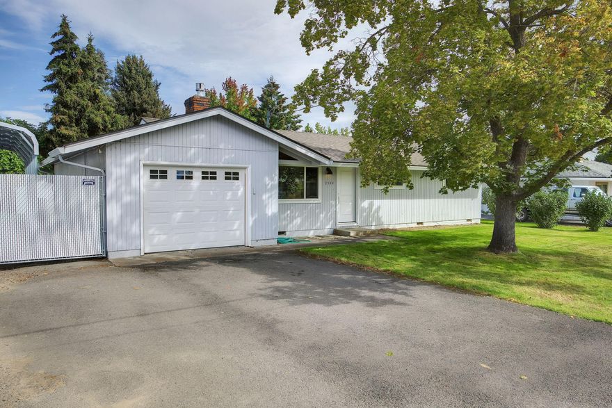 Single level 3 bedroom, 1.5 bath home nestled in a neighborhood in Northwest Medford. Featuring hardwood floors through living room, hallway and bedrooms. Nicely updated main bathroom. Natural gas fireplaces in both living and family rooms. Spacious fenced backyard with shed. RV parking with carport spans the length of the left side of property for all your toys. Kitchen refrigerator, garage refrigerator and microwave included. Pantry located in dining area. Home is located near shopping, schools, and restaurants.