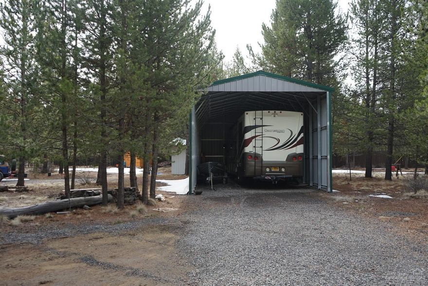 Looking for a wonderful vacation spot to park your RV or build your next home? This marvelous lot is at the end of the street & very private. Backs private forest lands. New Metal RV Ramada cover installed in 2016. Large enough to fit most vehicles. Nice clean newly updated laundry/storage building is a great convenience & washer/dryer go with the sale. Brand new Cedar storage building w/loft also installed within the last year. Beautiful building, great storage for all your needs. This has 2 full RV hook-ups with 30 & 50 Amp service.