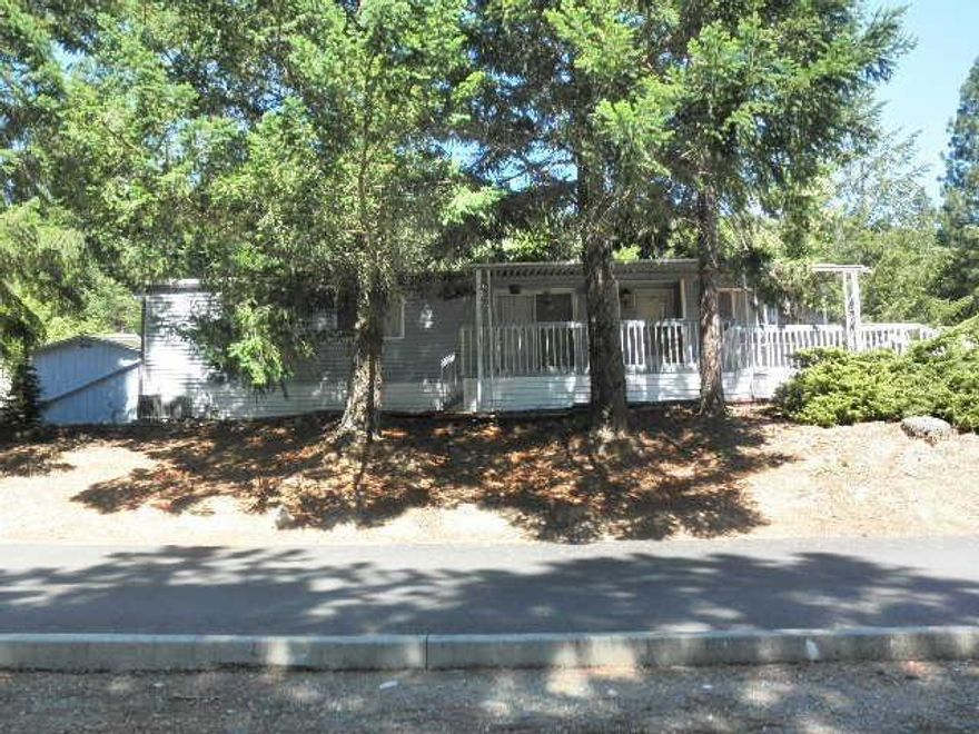 Nicely maintained double wide at excellent price. Generous open floor plan has dining, living room and family room. Breakfast bar in kitchen with storage galore. Tastefully decorated throughout. Spacious master bath with garden tub & separate shower. Beautiful mountain views. Outside sprinklers for easy care landscaping. Carport with plenty of extra parking in large driveway area. Two sheds for storage. Priced to sell quickly.