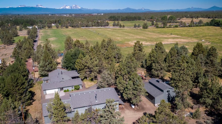 Builder's own home in the path of development!  This well-built single level home is peacefully situated on nearly 20 acres.  High quality working farm has a wheel line for irrigation providing 2-3 cuttings of hay yearly.  Large 50'x35' shop with 12' doors. Custom Hay barn with animal fencing. This would be the perfect working property for a contractor or 4H supporter.  Our research has this property approximately 6-7 years away from the next UGB expansion.  The City of Bend has installed a major sewer interceptor adjacent to the property line.  See conceptual site plan for possible development plan. Buyer is responsible for any and all diligence regarding future development.  Owner will carry for qualified buyers with $500K down at 5%