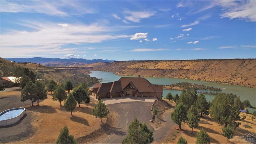 Rare Full Lake view property. Custom home, 6000+sf,5B/R,4.5 BA.& Office. Plus Studio w/B/R, Kit.& Bath in Pole-barn.Exquisite kitchen, Eng. hardwd flrs,granite throughout, 2 Wood FP + 2 Propane FP, ALL rooms have Lake & Mtn views. Full basement w/bar, wine cellar, exercise rm, & more. 2 Full length decks & covered outdoor kitchen.4 car attached and 2 additional in Pole-barn. Custom, Custom, Custom. Must see to appreciate. Watch drone video.