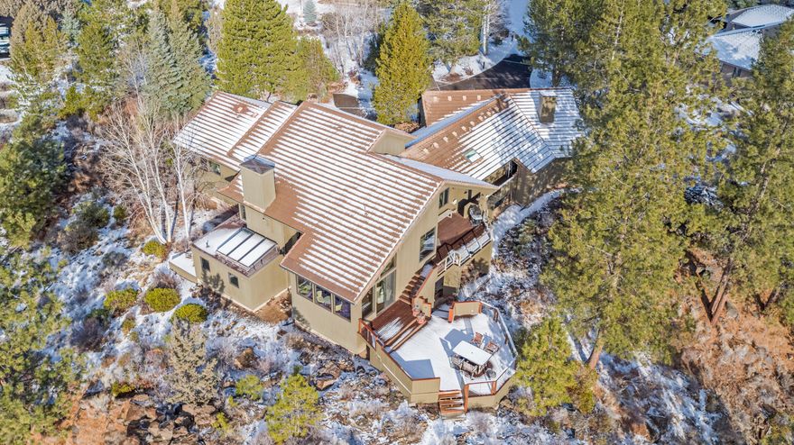 This spectacular custom and updated Mountain Modern home is one of the premier lots in Sunrise Village. The home sits on a .77 ac parcel that juts out over the river rim of the Deschutes, surrounding the home with nature's wonders. 3 ensuite bedrooms, primary on the main with luxurious bathroom and walk-in closet. A 2nd bedroom has a small bonus area, with its own private deck & stubbed for a sink that could be a mother-in-law space. The modern kitchen incl. sub-zero fridge, Wolf range, custom seating bar, and is open to the living room and dining area with its own wet bar. Additional spaces are: large office/flex, sun room, and laundry/project area that could be a 4th bedroom. 4 of 5 baths have radiant floor heat. There is solar-heated water and more storage & amenities than can be listed. Including a heated 3-car garage with utility sink & extra storage room. Sunrise Village is a gated community that includes an updated lodge, pool & spa, tennis courts & potential RV storage.