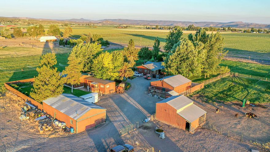 Unique and rare opportunity to own this meticulously maintained and self-sufficient Yak farm with 2 residences and a separate quest quarters. Main home has 4 bedrooms, 2 baths and is 2,346 sq. ft. Newer Blaze king Princess woodstove completely heats main house. Second residence is 3 bedrooms, 1 bath with bonus room, 1,432 sq, ft.,is ADA compliant. Both residences have a new metal roof completed July 2021.  Guest quarters is a 16x30 studio apt. with kitchenette and 1 bath. There is a total of 6.64 acres with 5.6 acres of O.I.D. irrigation and a 3 acre hay field that produces more than 12 ton of hay per year. There are several outbuildings including 2 shops, hay shed, storage building and barn. Sale includes new tractor (70 hrs.), including all attachments, all haying equipment, Kubota diesel side by side, gas and diesel fuel tanks, etc. All livestock is also included in the sale. Pride of ownership is clearly evident at every turn on this exceptionally cared for property.