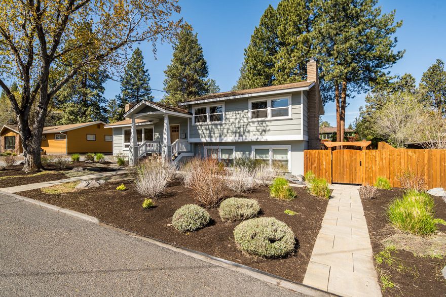 Nestled on a spacious lot in midtown Bend, this mid-century gem exudes charm & efficiency, boasting a perfect Home Energy Score of 10. Beautiful xeriscaping enhances the curb appeal while offering low-maintenance landscaping. Solar panels, capable of producing 13 MW per year, exceed the energy needs of the ave. US household. A wood-burning fireplace downstairs was converted to a convenient gas fireplace, & a second wood-burning fireplace upstairs includes a gas igniter. Refinished hardwood floors, new carpet, & bathroom upgrades enhance the interior. The detached garage has a finished interior with insulation, a 220V outlet suitable for an electric car charger or dryer. A 22 KW Generac backup generator ensures uninterrupted power supply. Strategically placed PVC pipes in the yard offer flexibility for future raised beds. Enjoy outdoor living on the new deck in the backyard, perfect for relaxation and entertaining. Conveniently located near downtown Bend and recreational opportunities.