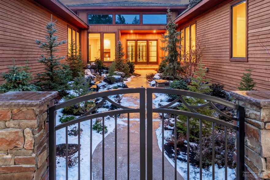 Newly constructed SINGLE LEVEL home combines a blend of Modernist contemporary architecture with classic northwest style. Behind gated courtyard walls & nestled within nearly 1/2 acre sanctuary, waterfalls flow into a rippling stream rolling under the pathway to the entry of this stunning home. Views of backyard waterfalls are visible thru the glass walled sunroom, enclosed via a state-of-the-art stacked panel doorway. Gourmet kitchen inc top-of-the-line appliances, 7' wine cooler, & quartz island w/ waterfall edge. Around the corner, an amazing Butler's pantry, w/ addtl cooktop, refrigerator, sink & two dishwashers. Master suite rivals a luxurious mountain resort, inc floating fireplace & lavish bath w/ quartz topped dual sink vanities and his & her'' water closets. Private guest wing incl two full en-suite bedrooms. 1,400 square foot, 4-car garage w/ electric car charging station & built-in cabinetry. Cedar siding, stone & tile roof work in unison to blend with surrounding landscape