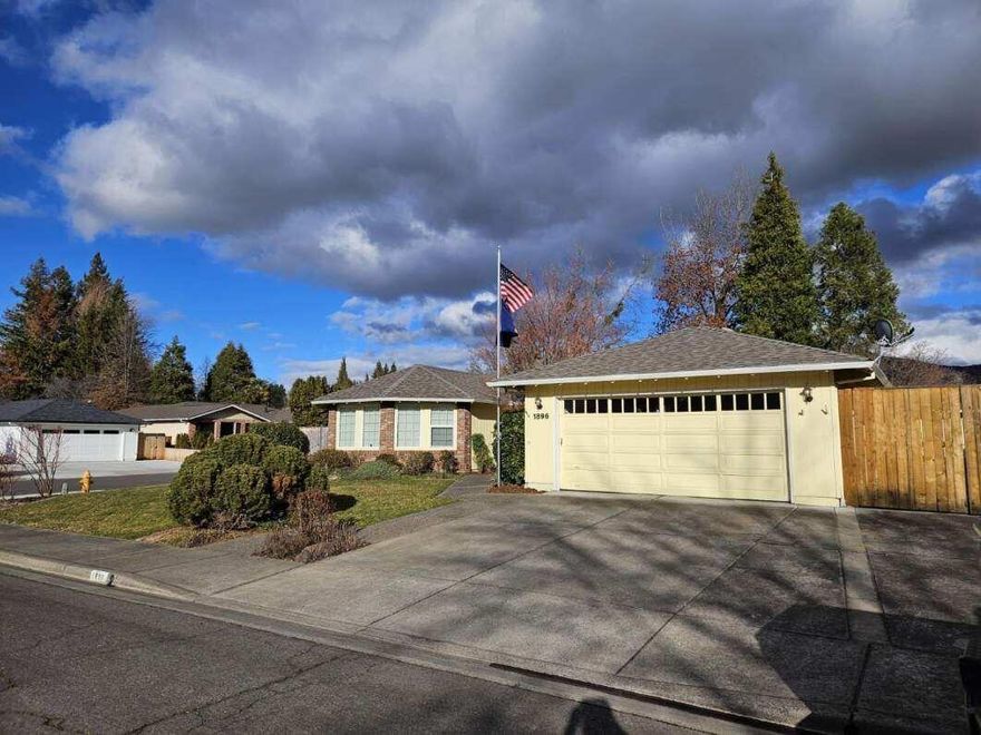 Charming home in desirable east Medford neighborhood sits on a .25 acre corner lot with spacious parking. Big living room with a large bay window and formal dining. Family room has built in shelving, gas fireplace and outside access to a covered patio. Open kitchen offers tile countertops and plenty of storage space. With stainless appliances, double oven, dishwasher and an over hood microwave cook top stove. Master suite with outdoor access, walk in closet and large bathroom. Two other spacious bedrooms with nice closet space. House is ADA friendly with wide hallways, doorways, ramps, ADA compliant tile shower and flower beds. Has upgraded electronic air purification system. A detached 460 sq. ft. shop w/ electric and water plus extra room. Home has a 2-car garage, RV parking and newer 8 ft cedar fencing. There are fruit trees and many flowering bulbs and roses.