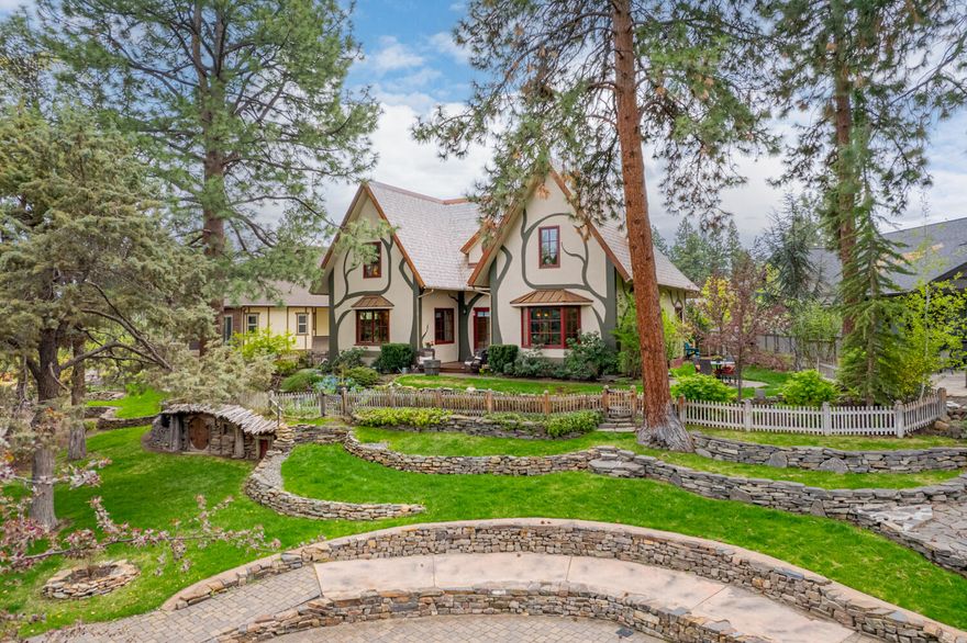 Dreams come true in this custom European-style Tudor storybook home.  One-of-a-kind stylistic design is built into every detail of this themed house.  Aptly called ''The Butterfly Cottage'' and the ''Hobbit House'', you will find unique features woven purposefully.  From the celtic butterfly hand-carved in the exquisite marble mantle to the hobbit hole artfully crafted into the landscaping, features include soaring open timber-framed 25 ft ''cathedral'' ceiling; faux thatch roof; rich bamboo floors; japanese cypress soaking tub; and granite, marble & river stone tile.  To make your life easier you will enjoy built-in vac system, on demand hot water, and high efficiency gas heat and cooling. Hard-to-find primary suite on main and a den/office; 2 bonus areas upstairs + exercise room. Chef's kitchen boasts a large island and high end appliances, incl. a Viking range. Oversize garage has a hot/cold faucet. Green built/Earth Advantage amenities incl. Life Breath heating & SIPS construction.