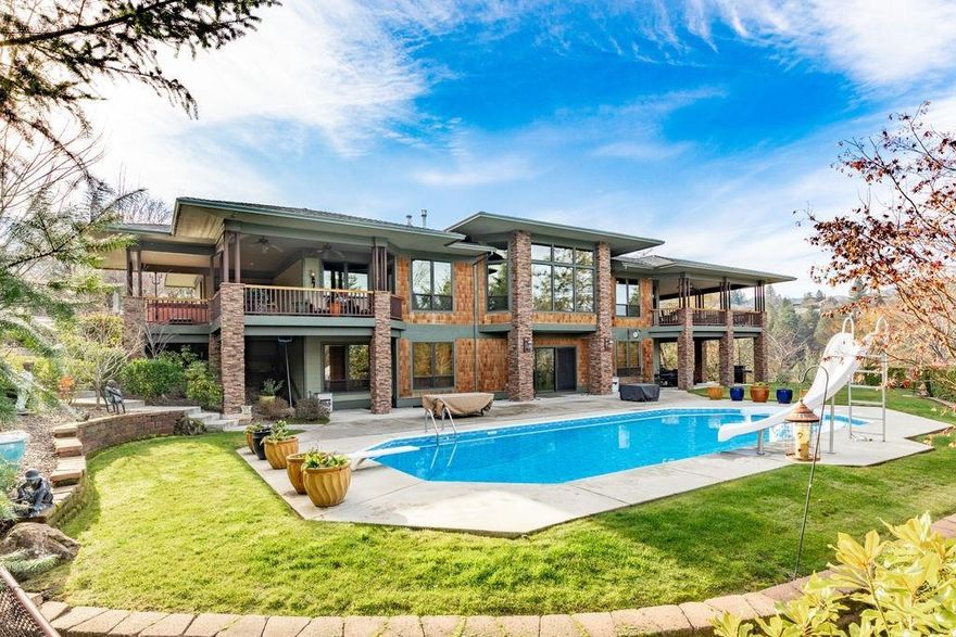 Spectacular home on a 1.07 acre view lot in a prestigious neighborhood, only blocks from historic Jacksonville. This custom built home was designed for the site to maximize views and privacy. Gated entry with a circular driveway and large portico entry. Beautiful kitchen, designed for entertaining and those who love to cook; equipped with 10 ft. long island, Wolf range, walnut cabinetry, cherry hardwood floors, and walk-in pantry. High vaulted ceilings with 9 ft tall windows. Built-ins throughout. The master suite and a large, open great room are on the main level. Downstairs has a large recreation room with a wet bar. Each bedroom has it's own bathroom. The home has 1,100 sq. ft. of deck space. Over half of the deck space is covered with powder coated steel railings. Oversized, 3+ car garage. Separate 1,000 sq. ft. guest house. Large, salt water, solar heated pool. This home has all city services. The entire property is fenced. This home is meticulously cared for.