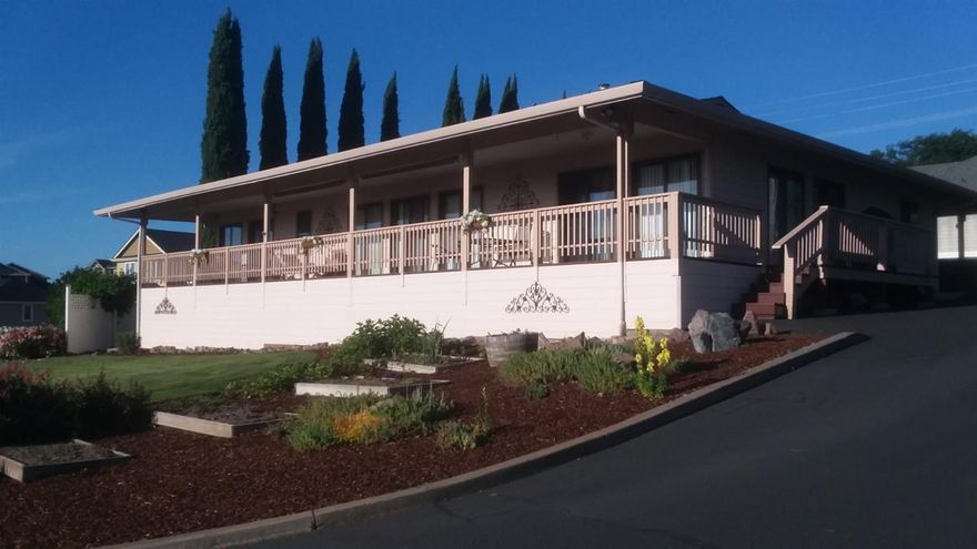 Like new and with views (city/mountains) on half acre (drive-thru RV parking w/hook-ups). 3 beds/2 baths 2,128 sq. ft. with 3 car garage and plenty of turnaround space. Not a thru street. Updated kitchen with pantry includes abundant storage. Large built-in entertainment center. Open floor plan enhanced by vaulted ceiling and wall to wall wood-framed windows. Solid doors. Quiet interior. Master provides spacious walk-in, slider to deck, double vanity sink. Marble counters in both baths. Large utility room w/sink. Auto sprinklers. Solar tubes in kitchen, hallway and 3rd garage. Huge deck, workshop area and raised garden beds (grapes/artichokes/plums/rhubarb). Block and vinyl fencing. 8 year old roof. Since purchase, new granite counter tops, HVAC, oven, d/w, plumbing fixtures, shower, all flooring, 50 gal. water heater, landscaping, stone walkways, boat port, and addn'l bar-b-q deck. Gas avail.. Warranty incl.. One owner is lic. OR realtor.