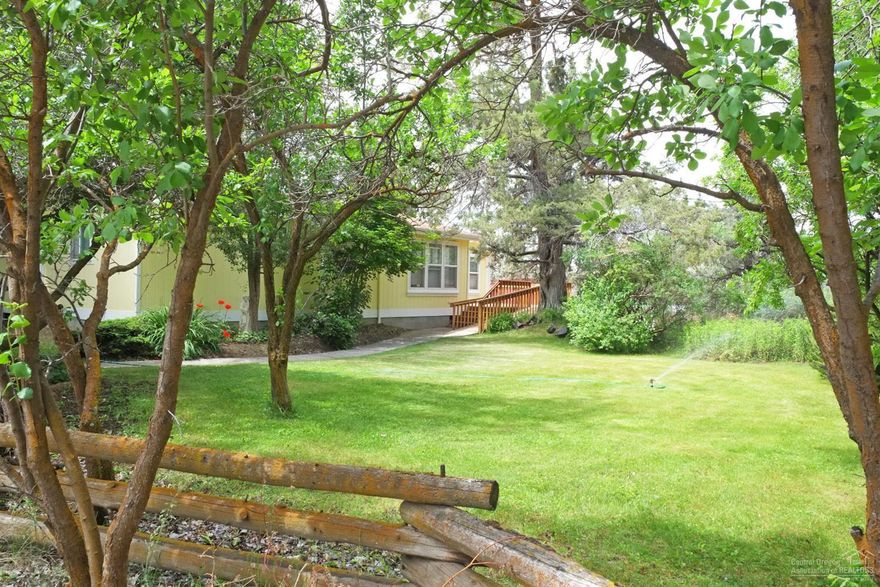 Ever dream of Organic Farming? Raising horses, sheep, goats? Picture a level 5.88 acres in grass with 4 acres of irrigation & pond. It is fenced & cross fenced with buried lines & hand lines. 40 ton hay storage, 3 stalls with paddocks. A great triple wide home of 1956 sqft with exterior painted in 2016 & new roof in 2015. Huge wrap around decking features a serene setting of mature trees & Cascade views.Time to live your dream!