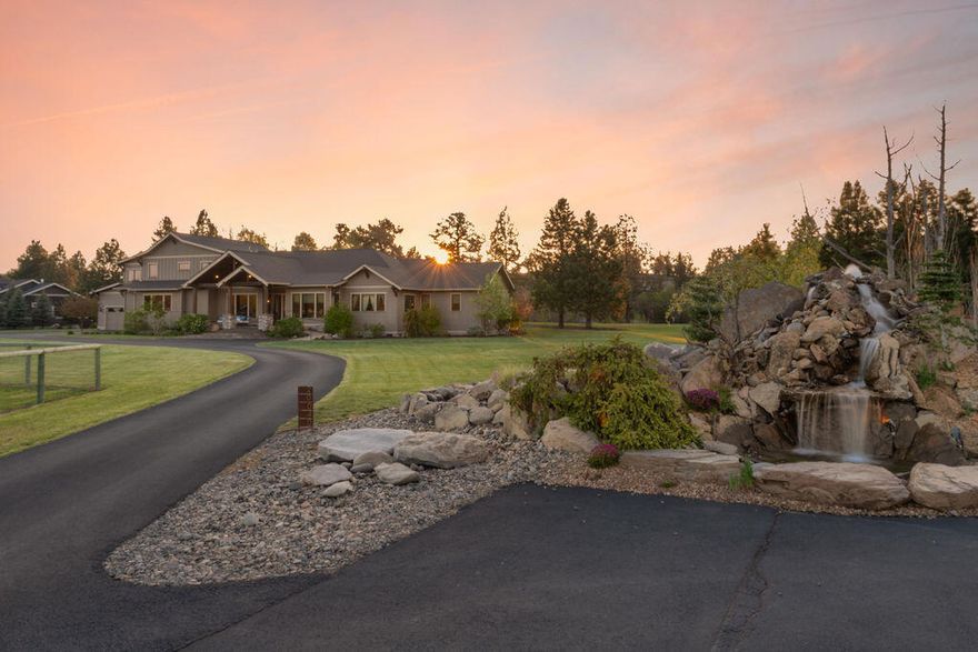 In the heart of Tumalo, nestled amidst sprawling pastures & the Deschutes River sits an extraordinary estate that has been meticulously designed for the ultimate living experience. The majestic entrance, flanked by a dining room & office, leads to the beautiful great room w/ vaulted ceilings, custom finishes, & a view of the river. The kitchen is replete w/ high end appliances, a large central island, & a butler's pantry. The ADA-compliant primary suite & guest suite include heated bathroom floors. At the home's south end you'll find a laundry room, access to two garages, & the entry to an incredible game lounge featuring a floor-to-ceiling stone fireplace & a bar w/ sink, microwave, & beverage fridge. Two staircases lead upstairs to four guest rooms, a loft, & bonus room. The estate grounds feature a fenced & irrigated pasture, raised beds, mature trees, & a wonderful backyard gathering space w/ a custom hot tub, concrete fire pit & covered patio, just steps from the Deschutes River.
