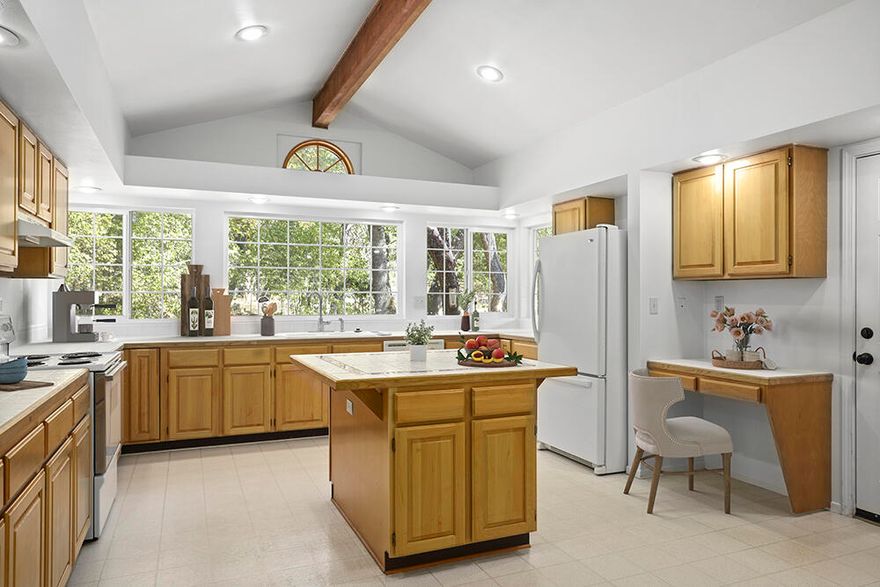 Lovely single level home set in the desirable Colonial Valley, full of charm and character! Features: 3 bedrooms, 2 baths, 1814 sq.ft. on 1.03 acre lot. New interior paint, all new carpets, and updated bathroom. Front porch sits back off the street for privacy, fenced and gated, detached garage, fruit trees, large fenced planting garden, potting shed, equipment shed and covered back deck. A warm and charming living room with large rock fireplace with mantle, gas heat insert, custom built in cabinet, large windows with picturesque views. Hardwood floors throughout the entry, in the separate dining room and pantry/wet bar. Spectacular custom kitchen with vaulted ceiling, tons of cabinets, desk, broom closet, large island with cabinets and drawers, the wrap around windows let in plenty of sunlight and beautiful views of back yard. Master bedroom with attached bathroom.