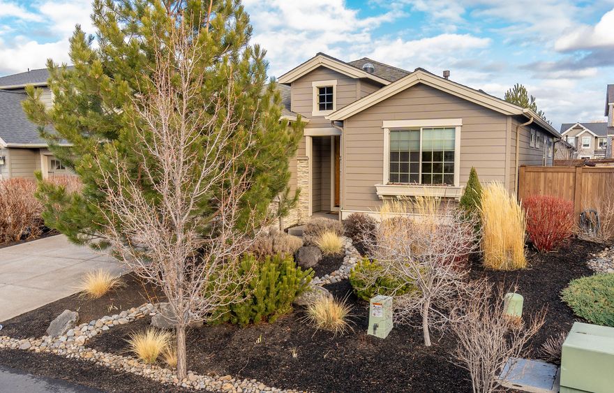 This single level Pahlisch home offers the seamless integration of wood floors, stone details, and modern finishes creating a sense of rustic elegance and timeless charm. One highlight of the spacious kitchen is the walk-in pantry, offering plenty of storage space for ingredients, small appliances, and pantry essentials. The large kitchen island is perfect for entertaining or meal prep. The primary suite offers privacy from the secondary rooms with an en suite complete with walk in shower, soaking tub, dual lavs and a walk in closet. For low maintenance the front and back yard are xeriscape and have mature trees and shrubs. The east facing patio is perfect for bbq's and summer nights. The garage offers plenty of cabinets and storage for all your toys. The Bridges community amenities include a clubhouse, pool, kiddy pool, jacuzzi, gym, sport court and play yard. There are acres of walking paths that meander throughout the community and lead you to the 37 acre Alpenglow park.