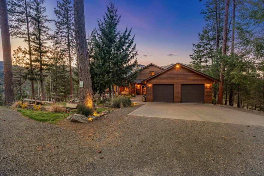 This 9-acre retreat at the base of Boaz Mountain boasts a lodge-inspired, custom home that spans 3,738 SF. The home features vaulted ceilings, hardwood floors, custom woodwork, wood cabinetry, floor-to-ceiling windows, & cedar siding. The open-concept floor plan includes the expansive master suite, kitchen, dining room, living room, guest bath, laundry, & 2 guest bedrooms all on the main level. Additional features in the home include a large kitchen island, walk-in pantry, pine-finish ceilings, rock fireplace, and more. A spiral staircase leads to the craft room/office, & the daylight basement includes a large bonus room, woodshop, storage, & full bathroom. The easy-care landscaping is fully fenced w/flower garden, water feature, & exclusive privacy. There is also a 1,000SF+ deck, lower-level patio, on-demand backup generator, 2-car garage, RV pad, carport, & storage shed. The property is also teeming with recreational opportunities w/access to 10,000+ acres of public lands!