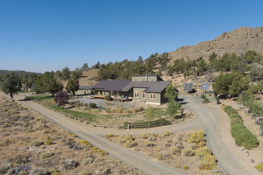 Located in the Oregon Outback, a refuge from dystopia. Secluded 240 acre retirement ranch located in Central Oregon's high desert. This is a complete self-sufficient, calm, and serene residence. Comfort is foremost in this 3 bedroom, 4 bath home built in 2002. Main living space offers two bedrooms, office/craft room, sitting area, lofted bedroom and bath, efficient kitchen with quartz counter tops, farm sink, hardwood floors, wood stove, dedicated laundry and mud room. Newly completed guest quarters with separate entrance, a great room featuring panoramic rim rock views, beautiful kitchen, one bedroom, bath and office space. Property is powered by extra high capacity 6.8 KW solar electric system, 32 solar panels, 16 - 6V batteries, high capacity back-up generator, 500 gal propane tank. Detached garage, concrete floor, carport, 24'x24 ' shop with workbench, reloading bench, 200 cubic ft armored vault. Room for a private air strip! This high desert paradise is a one of a kind property.