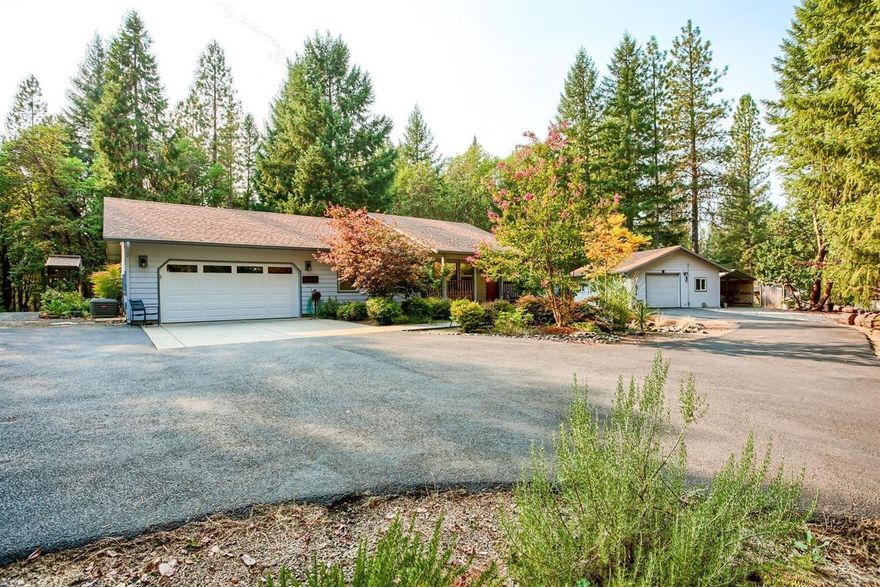 Single level, three bedroom home with attached 2-car garage and 720 sf detached shop on 4+ private acres surrounded in a quiet forested setting with gorgeous mountain views less than 15 mins to town, hospital and shopping. Light & bright kitchen with granite counters, tile floors & backsplash, stainless appliances and breakfast nook with bay window views. Vaulted living room with woodstove on raised tile hearth with beautiful views. Meandering paved driveway with gated entrance. This master gardener put up a fence to keep the deer & wildlife on one side and her greenhouse, raised beds, & beautiful landscape on the other! Equipment shed, flagstone walkways, strong newer well. Covered back patio with skylights. Laundry room with mud sink. But it's the shop with 220V power, certified woodstove and roll-up door that will bring you back for more! Fishing less than five minutes away.