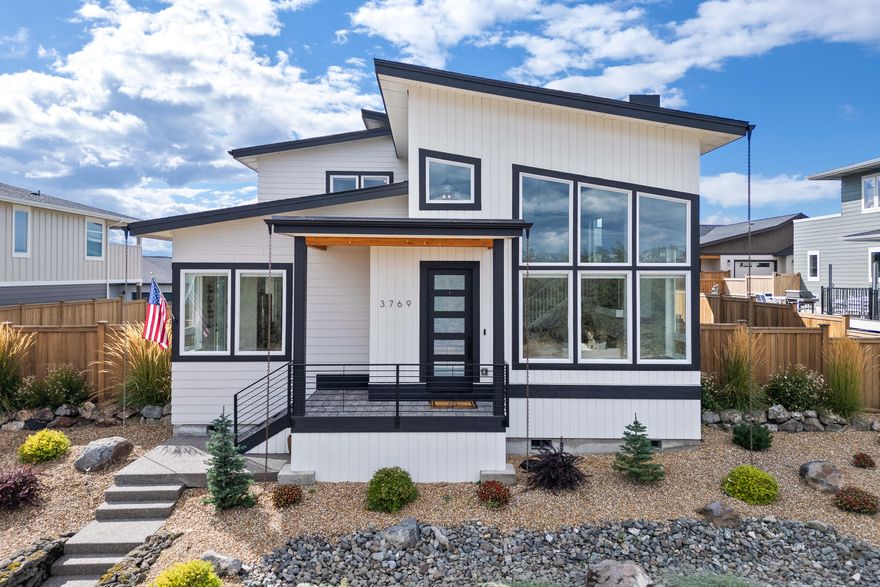 Welcome to the home you've been waiting for! Located in the desirable Red Tail Ridge neighborhood, this impeccably maintained 4-bedroom, 2.5-bathroom home offers 2,580 sq ft of stylish living. The main level features a spacious primary suite and an office/4th bedroom, while upstairs you'll find two additional bedrooms with a shared Jack and Jill bathroom, plus a bonus room with access to a rooftop deck showcasing stunning Cascade Mountain views. Mid-century modern design meets quality finishes throughout, with large windows providing abundant natural light. The elevated lot offers privacy, and the fully fenced yard includes a patio and relaxing hot tub. The 3-car garage with epoxy floors and behind-fence parking for all your toys adds extra convenience, plus it's perfect for storage or a workshop. With a 4-acre future park across the street and Redmond's amenities just minutes away, this home is the perfect blend of comfort, style, and convenience—truly a must-see!