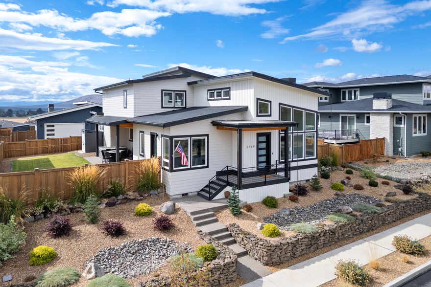 Welcome to the home you've been waiting for! Located in the desirable Red Tail Ridge neighborhood, this impeccably maintained 4-bedroom, 2.5-bathroom home offers 2,580 sq ft of stylish living. The main level features a spacious primary suite and an office/4th bedroom, while upstairs you'll find two additional bedrooms with a shared Jack and Jill bathroom, plus a bonus room with access to a rooftop deck showcasing stunning Cascade Mountain views. Mid-century modern design meets quality finishes throughout, with large windows providing abundant natural light. The elevated lot offers privacy, and the fully fenced yard includes a patio and relaxing hot tub. The 3-car garage with epoxy floors and behind-fence parking for all your toys adds extra convenience, plus it's perfect for storage or a workshop. With a 4-acre future park across the street and Redmond's amenities just minutes away, this home is the perfect blend of comfort, style, and convenience—truly a must-see!