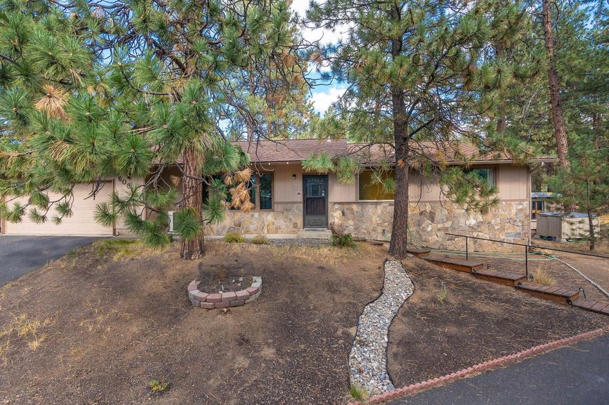 This is a wonderful opportunity to own a classic ranch-style home on a large 1/2 acre lot in a desirable location in SW Bend. The property boasts mature pine trees and is located just minutes away from popular amenities such as the Old Mill, Deschutes River, hiking trails, shopping, and restaurants. The home features a functional floor plan with nice separation between the primary bedroom suite and the other two bedrooms. There is also an additional room that can be used as a den, office, or formal dining room. The property is heated by a forced-air gas furnace with central A/C, and there is also a wood stove with a cozy sitting area for those cold winter evenings. The home also has an attached two-car garage and a storage shed for additional storage space. A new septic tank was installed in June 2022.