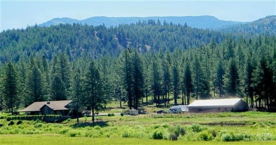 Pass through the gated entrance and find this rare private country mountain ranch with 238 acres featuring timber, 1.5 miles of fish-bearing Ochoco Creek and 166 acres of flood irrigated meadows. Many improvements enhance the ranch, including the Northwest style home built in 2004. The 3573 SqFt home has a full wrap-around porch, 2 master suites, and views from every angle. Luxury interior elements include high end features, appliances, cabinetry, and a striking rock fireplace.