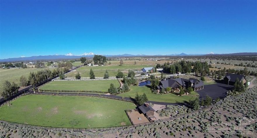 This distinctive Gentleman's Ranch is nothing short of exceptional. Over 4500 sf of sophisticated finish work in the main house, 9.28 ac. bordering BLM land with gorgeous Cascade views and direct access to mountain bike/horse trails, a swimming pond with beach area, 900 sf guest quarters above a 2500 sf shop/garage with full RV amenities and two double deep bays, enviable fenced pastures with automated underground sprinklers, and loafing shed/hay storage area. This property is truly in a class by itself!