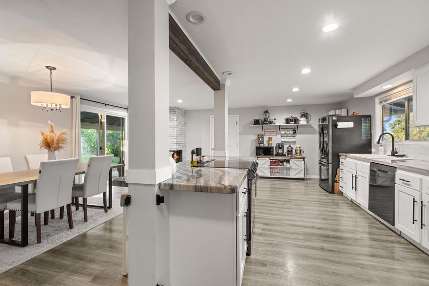 Completely remodeled and move-in ready, this beautiful home blends modern upgrades with standout curb appeal. The front yard offers low-maintenance landscaping with a drip system plus RV/boat parking. Inside, the open floor plan features newer stainless-steel appliances, a spacious kitchen island with bar seating, and a cozy dining area with a stylish fireplace. Generously sized bedrooms include a primary suite with a walk-in closet and granite counters. The fenced backyard offers sprinklers, a shade tree, garden shed, and trailer access through a utility gate. Enjoy the covered patio with gas firepit hookup for relaxing or entertaining. A two-car garage with gas heat and extra storage completes this impressive home.