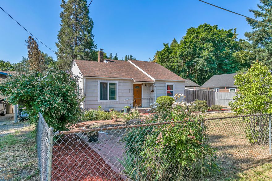 This charming and cozy 2-bedroom, 1-bathroom home is full of potential. It features a convenient indoor laundry room and separate dining and living areas, perfect for comfort and gatherings. The property includes a detached one-car garage/workshop, all set against a generously sized, fully fenced, and landscaped yard—ideal for outdoor activities or gardening, with Grants Pass irrigation rights. The backyard offers a chicken coop and run, along with fruit trees, including cherry, apple, nectarine, peach, and garden boxes ready for next year's veggies. Recent updates include a new mini-split HVAC system (installation completed by closing), fresh exterior paint, upgraded wall and floor insulation, and double-pane windows. Natural gas is piped to the property and is ready for connection. Whether you're seeking an investment opportunity or a place to create your dream home, this property offers endless possibilities!