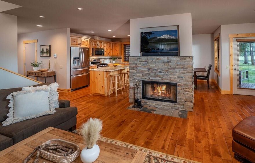 Welcome to your Sunriver oasis in the heart of it all! This immaculate 3-bedroom, 3-bathroom townhome offers 1,891 square feet of spacious living with no shared walls. Enjoy outstanding golf course views and abundant natural light streaming through the wood-wrapped windows. The beautiful, stacked stone two-sided gas fireplace creates a cozy atmosphere in the open living area. Step outside to the hot tub, perfect for relaxation after a day of play. The well-appointed home features a single-car garage and great storage options. The location is ideal for outdoor enthusiasts, with easy access to the bike path and the community pool. You are just a short stroll away from McDivots Café, the Woodlands Golf and Pro Shop, the SROA Owner's pool, and tennis courts. Nestled within lush green space, the covered front porch invites you to unwind and soak in the scenery. This lovingly maintained townhome is not a rental, making it a perfect primary or vacation home. Create your Sunriver legacy.
