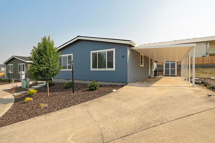 PRICE IMPROVEMENT! Impeccably maintained, 2 bed/2 full bath home with bonus room/office. Vaulted ceilings and large windows greet you as you walk into the open floor plan with living, dining and kitchen. Large kitchen island with breakfast bar, white cabinets and SS appliances. Utility room off kitchen with door to covered carport. Wide hallway takes you to bonus room/office and guest bathroom w/shower/tub combo. Guest bedroom and primary suite towards the end of the hallway. Primary bedroom features large ensuite bath w/dual vanity and walk in shower. Large linen closet in primary bath and walk in closet in primary bedroom. Seller has spared no expense for tiered landscaping w/ automated drip system in front and back, turf lawn, and paver patio that complete the oversized backyard. Incredible area and space for entertaining!! Also includes shed for storage and deep covered carport. Come and view this beautiful home today!