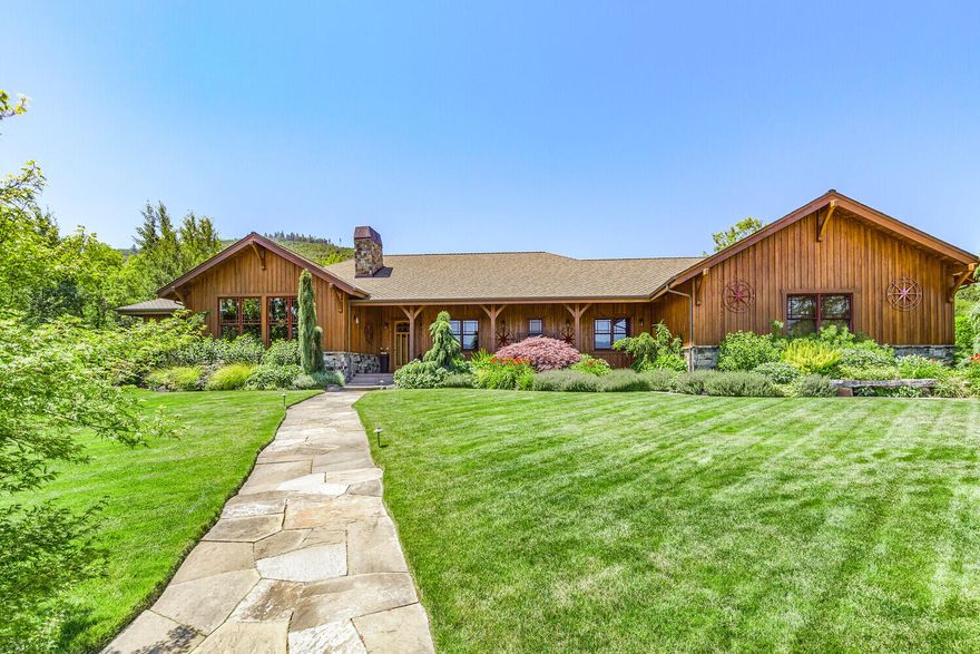 Equestrian estate w/ lodge like feel on appox 8.11 acres perimeter fenced & crossed fenced. Contemporary open floor plan boasts wood floors, cathedral wood ceilings w/beams. Primary bedroom has spa like bath, double sinks, soaking tub, dbl walk in shower, well designed walk in closet. 2 additional large bedrooms, main bath and 2 half baths. Gourmet kitchen, huge island, dining area & living w/stone faced gas fp & views of Grizzly Peak. Temperature controlled wine room for 900+ bottles. Custom cabinetry throughout. Family room off patio & heated swimming pool, fire pit & hot tub. Entertaining space galore. Private pond with dock. Exquisite landscaping by Solid Ground. Separate shop & barn w/attached loafing areas, hay storage, tack room, round pen, approx 2 acres of drylot to 4 one acre irrigated pastures. Great well & water rights to Dunn Ditch & TID. Large artificial grass enclosure for your 4 legged friends w/doggy door to heated 3 car garage.