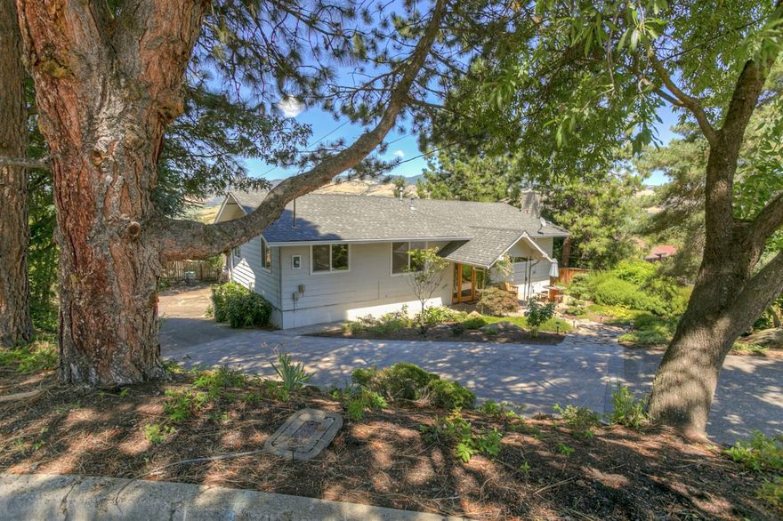 End of cul-de-sac privacy ensures peaceful living in this wonderful home that enjoys views of Grizzly Peak and adjacent park. Spend time on the back deck overlooking drought tolerant landscaping, fruit trees and lovely patio/hot tub area. Guests or in-laws will enjoy a private and bright daylight basement with its own full bath that opens directly to the garden. Natural light fills the main level that is perfect for entertaining. Master bedroom is also on the main and has sliding glass doors that take in the wonderful views. All of this yet still close to downtown Ashland.