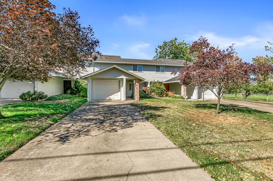 Well-maintained and move-in-ready home with high ceilings and two primary bedrooms with full ensuite bathrooms - centrally located near groceries, the Ashland Family YMCA, and future site of East Main Park! Fresh interior paint and all new carpets, toilets, smoke and carbon monoxide detectors in 2025. Main level features a vaulted living room with ceiling fan, adjacent dining area with sliding glass door to covered patio and fully-fenced back yard, kitchen with Formica dining counter, under-cabinet lighting, stainless double sink, dishwasher, refrigerator, electric range oven with hood, entry with coat closet with under-stair storage, powder room half-bath, laundry room, and one-car garage. Two upper-level primary bedrooms with closets and full ensuite bathrooms with tub showers. Association dues of $165 per month cover landscaping maintenance of front yards and all common areas.  Inquire for details