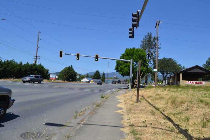 This is an exceptional investment opportunity for a commercial development. Located at the traffic signal on Williams Highway in Grants Pass. ODOT has noted that the this location can be turned into 4 way intersection with access directly into this property. Commercial frontage on a busy main highway with two parcels and the opportunity for retail or other commercial uses.  There is a home on one parcel that could remain a rental. You wont find a better commercial development parcel for the price. Great traffic count on a main highway with a nice car wash next door also for sale. Excellent opportunity for future or present growth.
