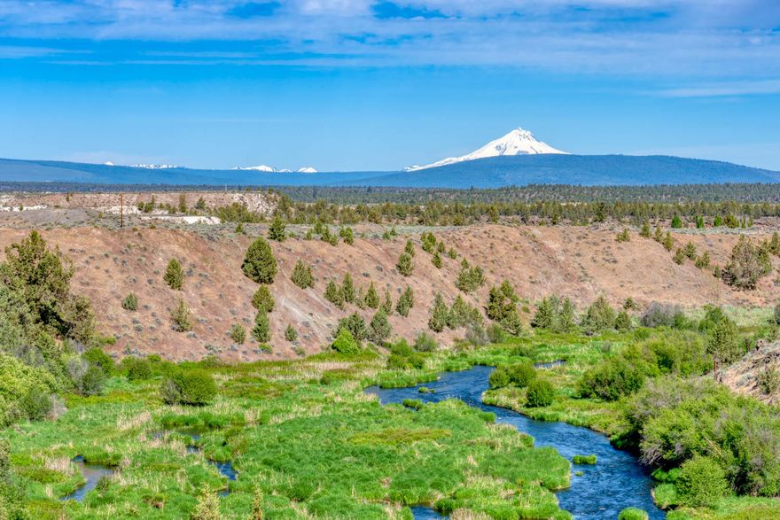 Deschutes River Front Acreage! 10 acres along the Middle Deschutes offers a spectacular building site with 180 degree river views with the Cascade Mountains in the background. Paved access, electricity available, standard septic feasibility and an existing well. The property gently slopes from the street to the northwest forming a flat bench with a premier building site before rolling off to the river. There are two adjacent parcels also available that create the possibility for a multiple home estate. With great mountain and river views, this is a rare opportunity to build your dream home.